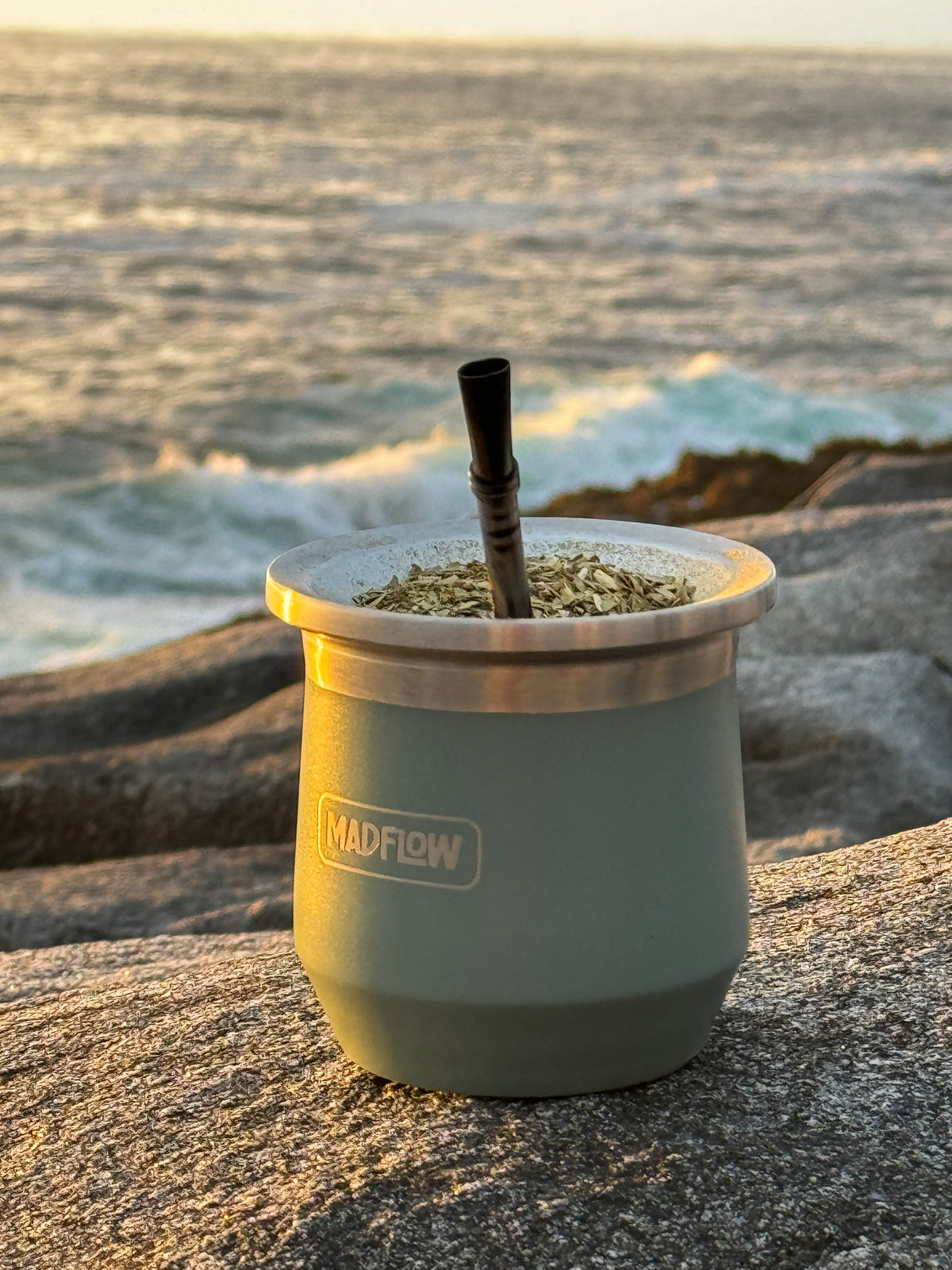 MADFLOW Forest Green mate cup on the rocks by the sea at sunset